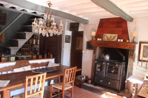 a dining room with a table and a wood stove at Casa Ceri in Casoli