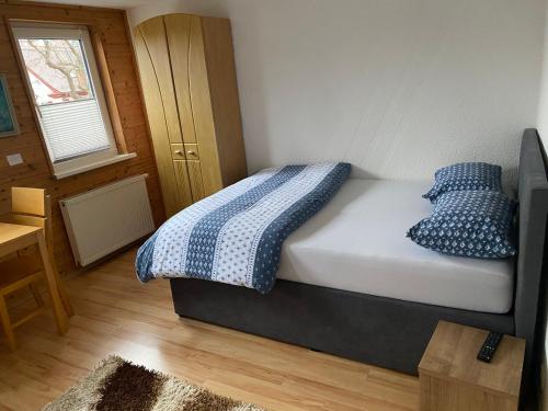 a bedroom with a bed with two blue pillows at Apartment in der Altstadt in Schwäbisch Hall