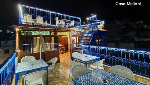 a balcony with tables and chairs on a cruise ship at Casa Meftah Blue in Chefchaouene