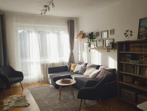 a living room with a blue couch and a table at Greenview Apartment in Budapest