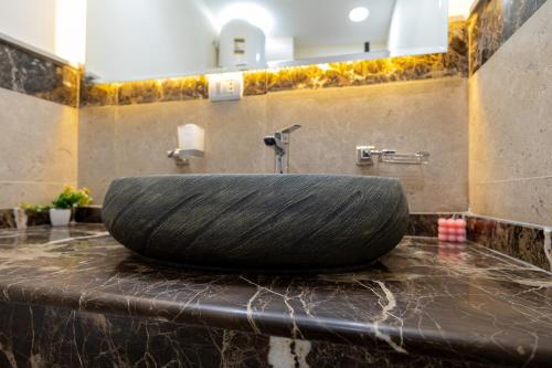 a large tire sitting on top of a bathroom sink at Marron 3b in Cairo