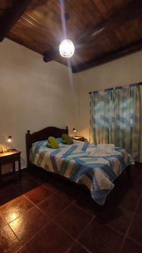 a bedroom with a bed with a blue comforter at LA MAISON in Lozano