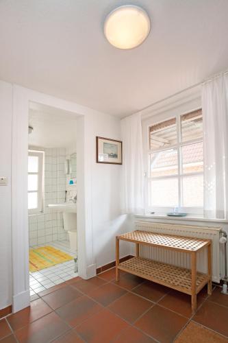 a bathroom with a bench in the middle of a room at Haus Detine - Wohnung 2 in Borkum