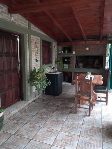 a porch with a wooden door and a table at Cabañas aromit in Villa Los Aromos