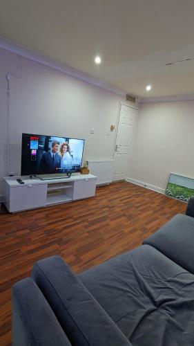 a living room with a flat screen tv and a couch at Private 1bedroom home in North Tyneside