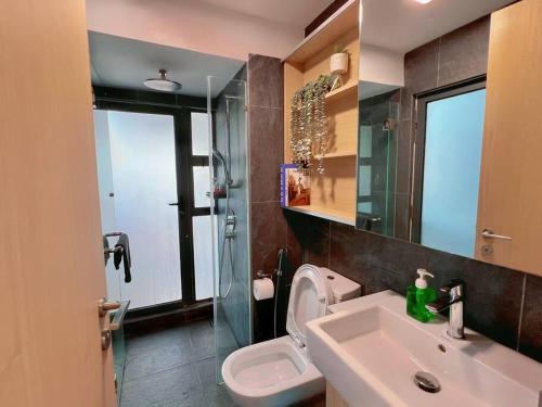 a bathroom with a sink and a toilet and a mirror at Duplex 4px@Colony, Near Quill CityMall & Monorail in Kuala Lumpur