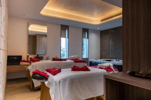 two beds in a room with red pillows on them at Welcomhotel by ITC Hotels, Jodhpur in Jodhpur