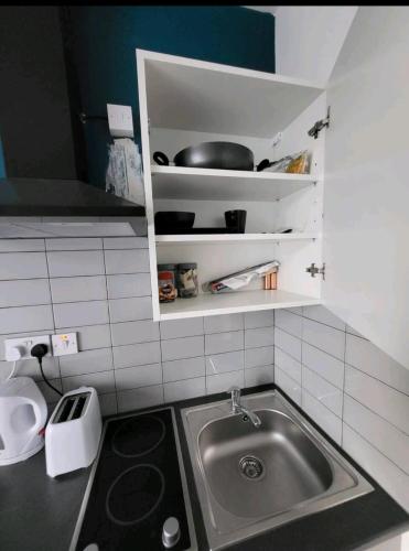 a kitchen with a sink and a counter top at Double room with Bathroom and kitchenette in Manchester