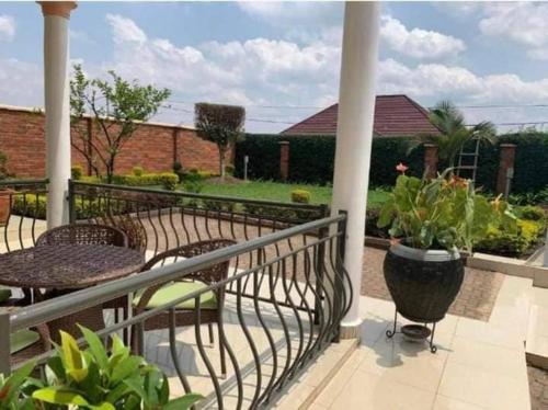 a balcony with a table and chairs on a patio at KingdomHomes. in Kigali