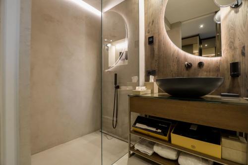 a bathroom with a sink and a glass shower at Collina Luxury Relais in Clusone