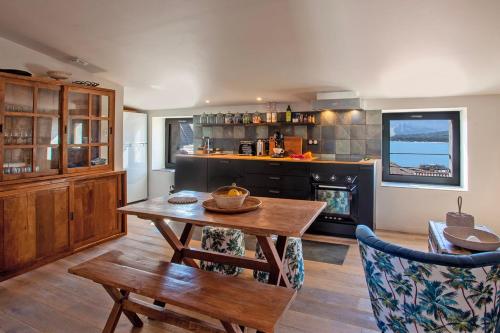a living room with a table and a fireplace at Mira appartement climatisé vue mer centre de Calvi proche port et plage in Calvi