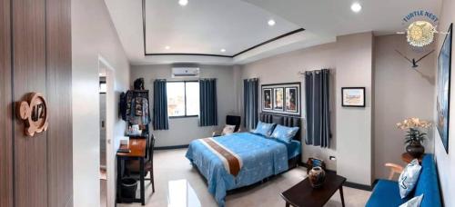 a bedroom with a blue bed in a room at Turtle Nest in Khao Tao