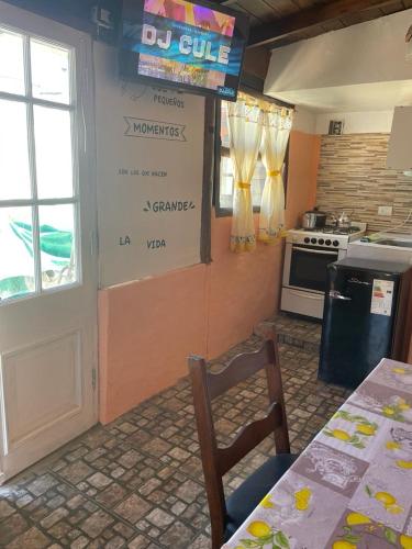 a kitchen with a table and a sign on the wall at Anmery departamento in Mar del Plata