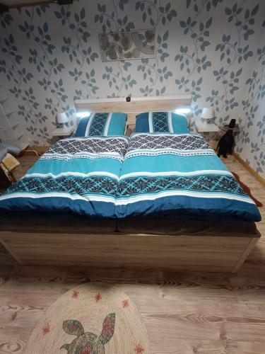 a bedroom with a large bed with blue sheets at Haus Luise in Stapelburg