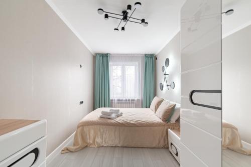 Ένα ή περισσότερα κρεβάτια σε δωμάτιο στο Two Bedroom Apartment In The Heart of Almaty
