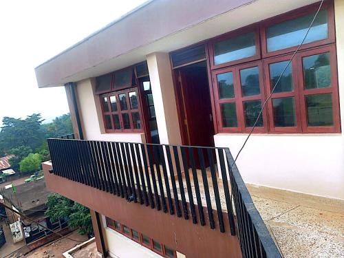 a house with a balcony with a red door at Hilton Hil Mountain View in Moshi