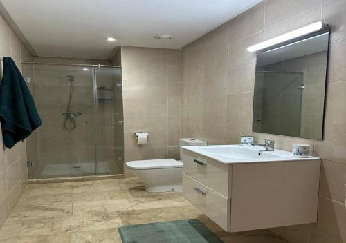 a bathroom with a toilet and a sink and a shower at Luxe en bord de mer à la Marina d'Agadir in Agadir