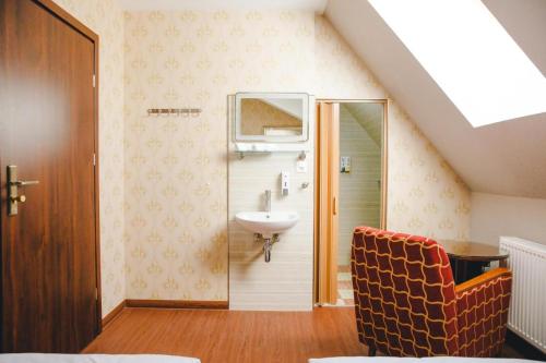 a bathroom with a sink and a toilet in a attic at Hotel Luzern Engel in Hitzkirch