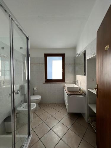 a bathroom with a toilet and a sink and a shower at Casa dell'amicizia in Castellani