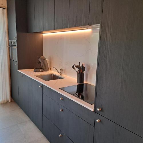 a kitchen with a sink and a counter at Dunehuys in Koksijde