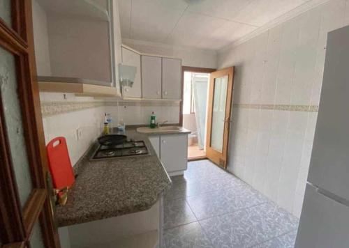 uma cozinha com um fogão e uma bancada em Paloma-habitacion del piso em Alicante
