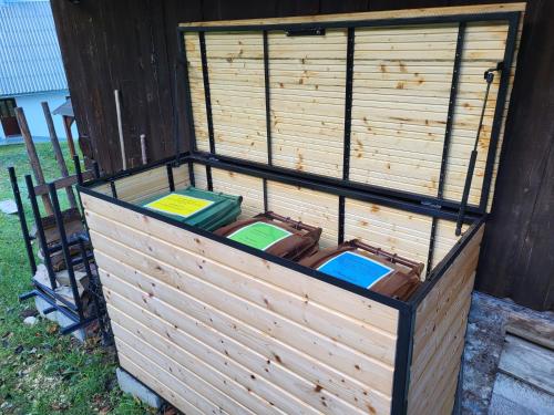 a wooden bird cage with four birds in it at Jurček Holiday Home in Kotlje