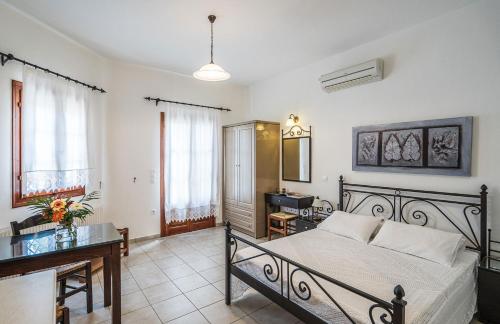 a bedroom with a bed and a desk in a room at Elaida Apartments in Apollonia