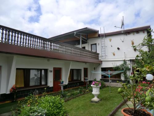 a house with a garden and a windmill at Pension Villa Brödel in Bad Blankenburg