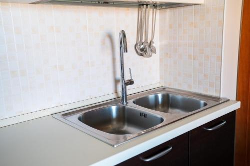 a stainless steel sink in a small kitchen at Residenza Piccolo Eden in Bosa Marina