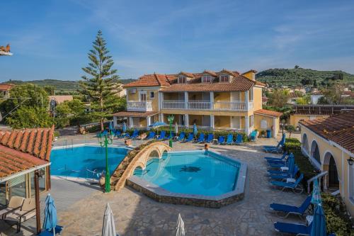 a villa with a swimming pool and a resort at Elpida Hotel in Alikanas