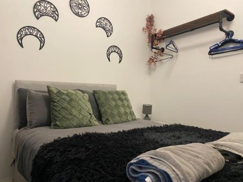 a bedroom with a bed with black and white decals on the wall at Bank Street Apartment 7 in Blackpool