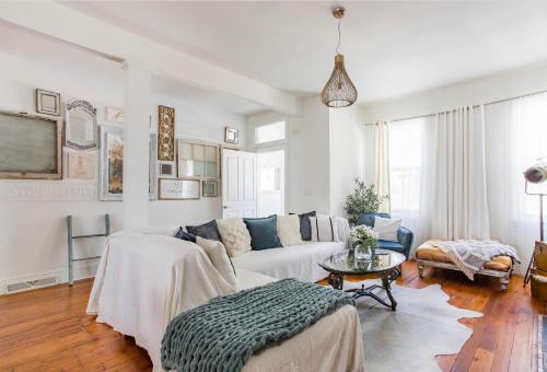 a living room with a couch and a table at Central Pittsburgh 5-Bed Haven in Pittsburgh