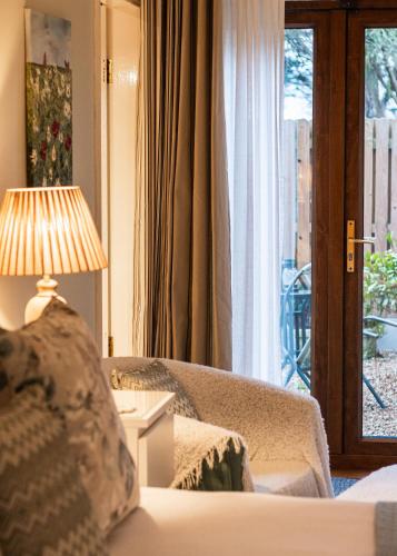 a living room with a couch and a lamp and a window at MOUNT BARKER in Swords