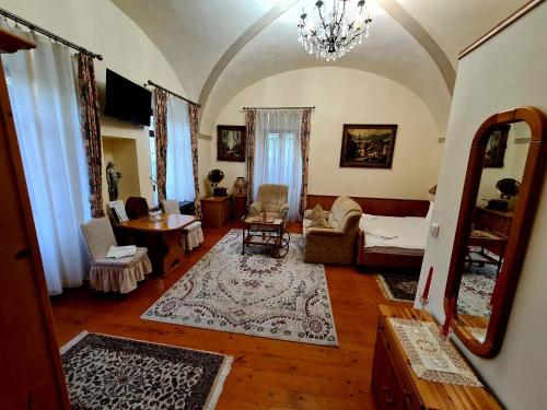 a living room with a couch and a table at Armenopolis - Adults Only in Gherla