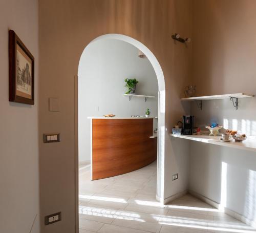 an archway leading into a kitchen with a wooden door at CONTE CAVOUR in Messina
