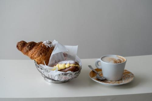 a cup of coffee and a basket of bread and a cup of coffee at CONTE CAVOUR in Messina