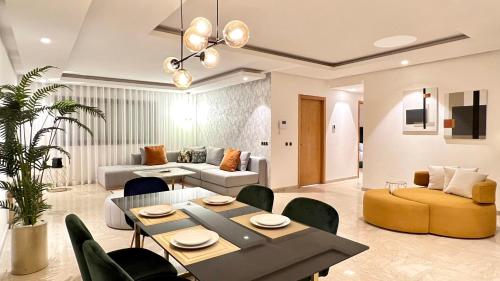 a living room with a couch and a table and chairs at Family 3 Bedrooms- By AppartAli in Casablanca