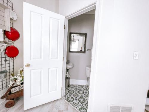 a white door leading to a bathroom with a toilet at Central Pittsburgh 5-Bed Haven in Pittsburgh