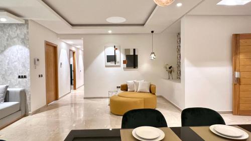 a living room with a yellow chair and a couch at Family 3 Bedrooms- By AppartAli in Casablanca