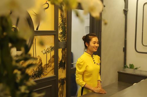 a woman standing in front of a mirror at SALA HOTEL HUE in Hue