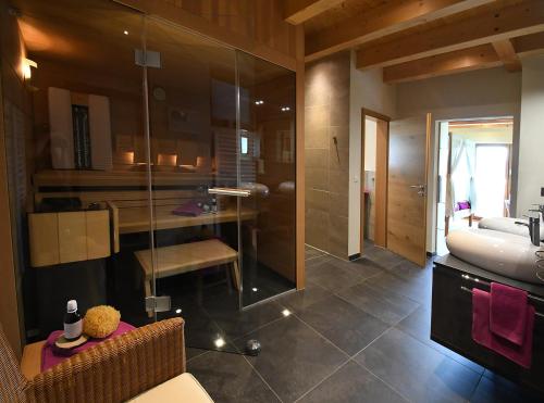 a bathroom with a tub and a sink and a toilet at Chalet Zauberberg in Zwiesel