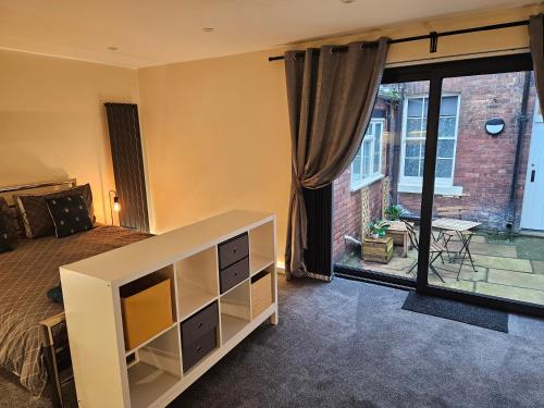 a bedroom with a bed and a view of a patio at Carlisle City Centre The Wash House in Carlisle