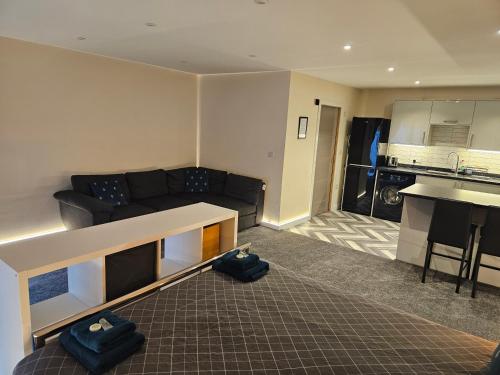 a living room with a couch and a kitchen at Carlisle City Centre The Wash House in Carlisle
