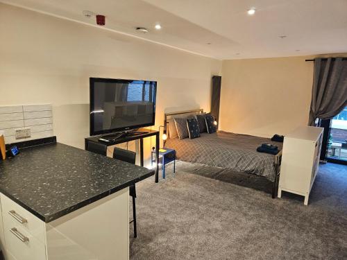 a hotel room with a bed and a television at Carlisle City Centre The Wash House in Carlisle