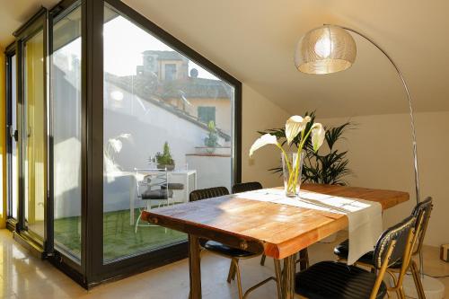 a dining room with a table and a large window at greve center apartments in Greve in Chianti