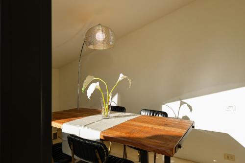 a dining room table with a potted plant on it at greve center apartments in Greve in Chianti