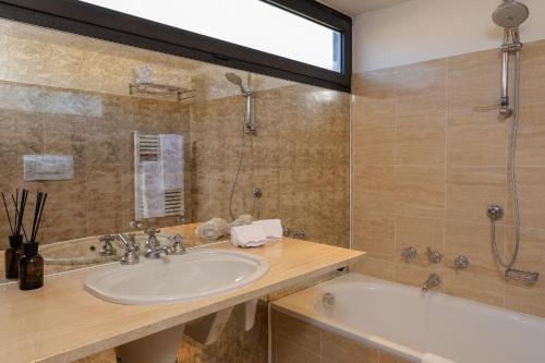 a bathroom with a sink and a bath tub at greve center apartments in Greve in Chianti