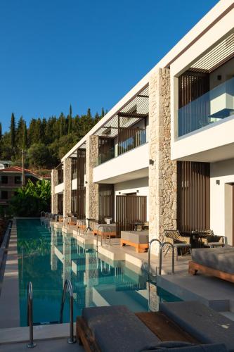 a building with a swimming pool in front of it at LAN-GO SIVOTA Luxury Living in Sivota