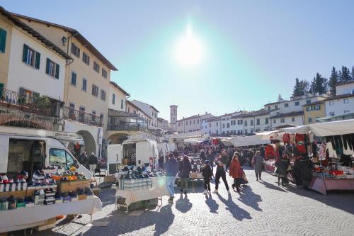 a group of people walking around a market in a town at greve center apartments in Greve in Chianti