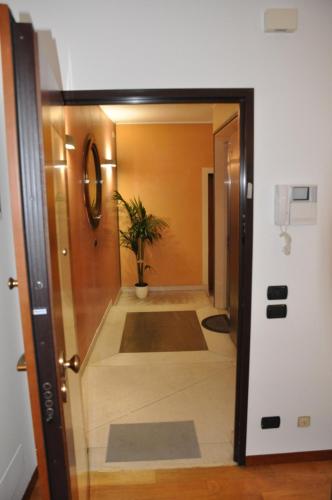 a door leading into a hallway with a potted plant at Ex Casa degli Artisti in Montebelluna
